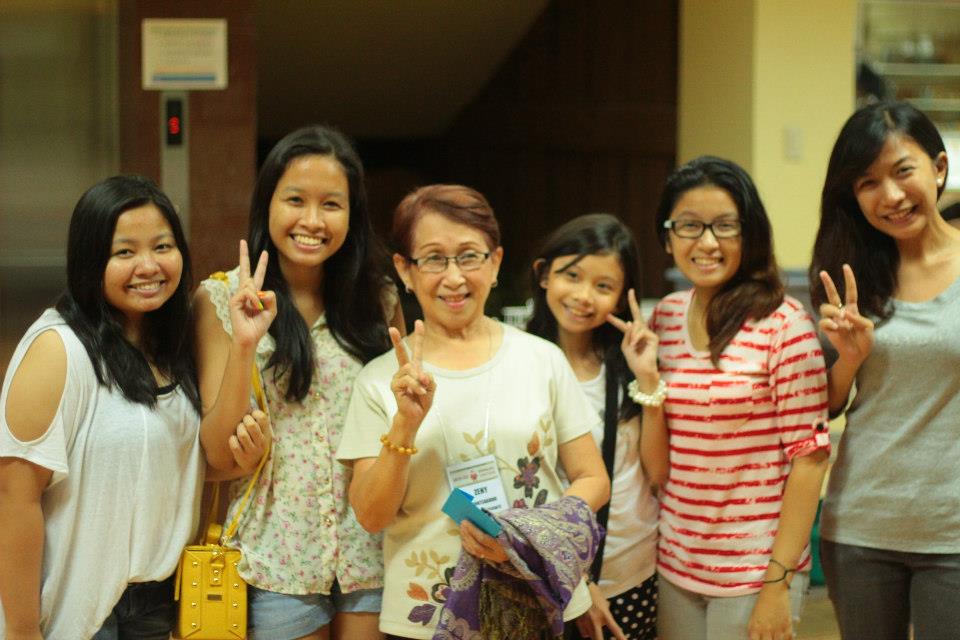Me and my cousins posing with our grandmother, who also happens to be the president of the convening organization